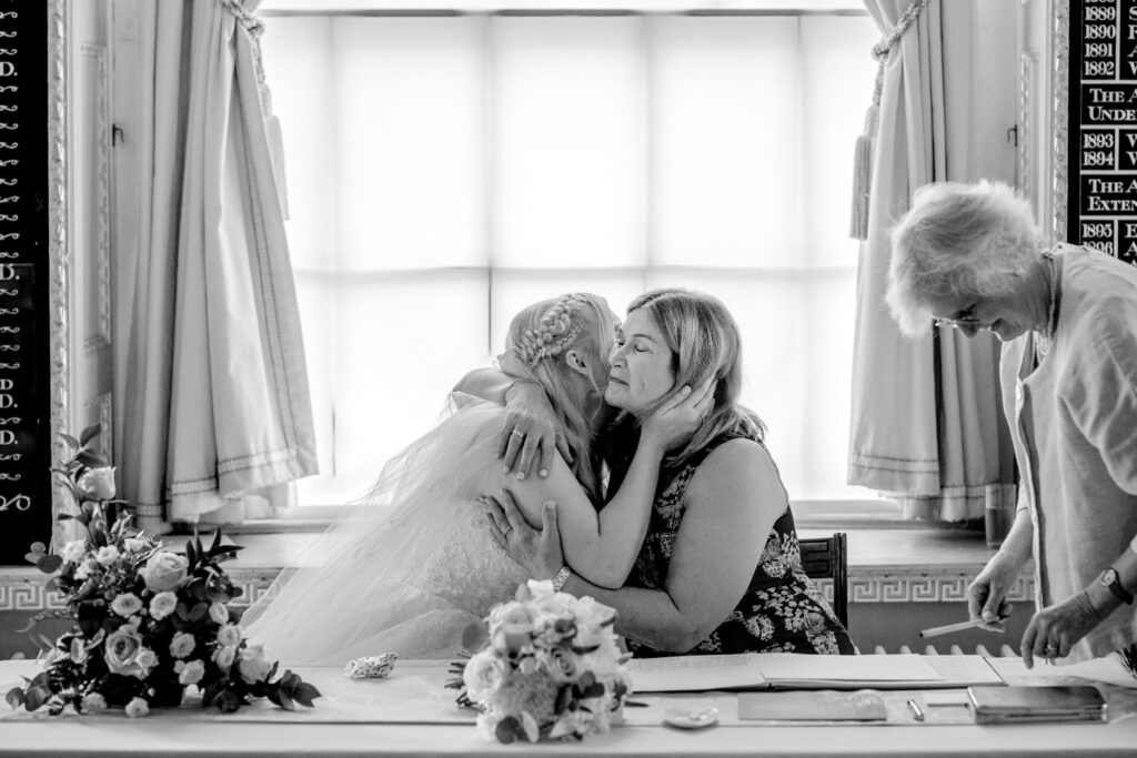 motherof the bride and daughter embrace after wedding at the council chambers in chichester west sussex